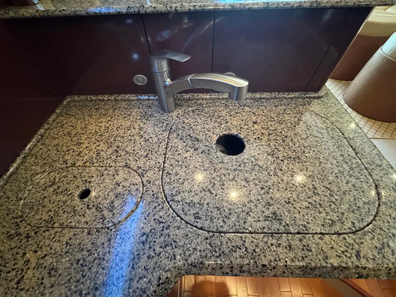 Slide: The Image of Granite countertop with sink and faucet on 2007 Sea Ray 52 Sedan Bridge yacht. - 32