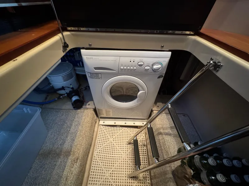 Slide: The Image of Laundry area with washing machine on 2007 Sea Ray 52 Sedan Bridge yacht. - 33
