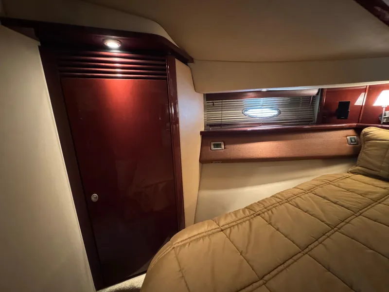 Slide: The Image of Interior cabin of 2007 Sea Ray 52 Sedan Bridge with wood paneling and cozy bedding. - 36