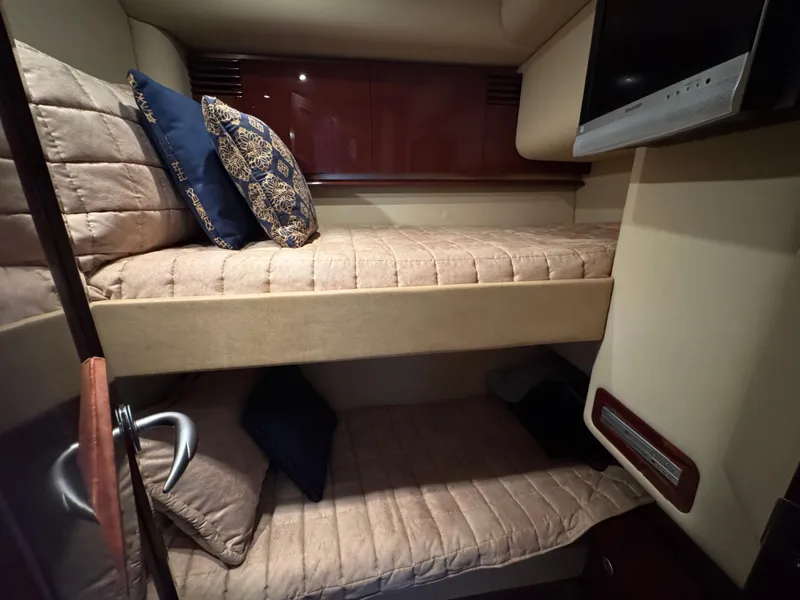 Slide: The Image of Interior of 2007 Sea Ray 52 Sedan Bridge with cozy bunk beds and decorative pillows. - 40