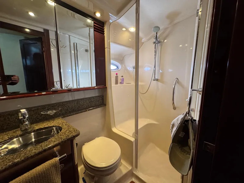 Slide: The Image of Luxurious bathroom in 2007 Sea Ray 52 Sedan Bridge yacht with shower and granite countertop. - 41