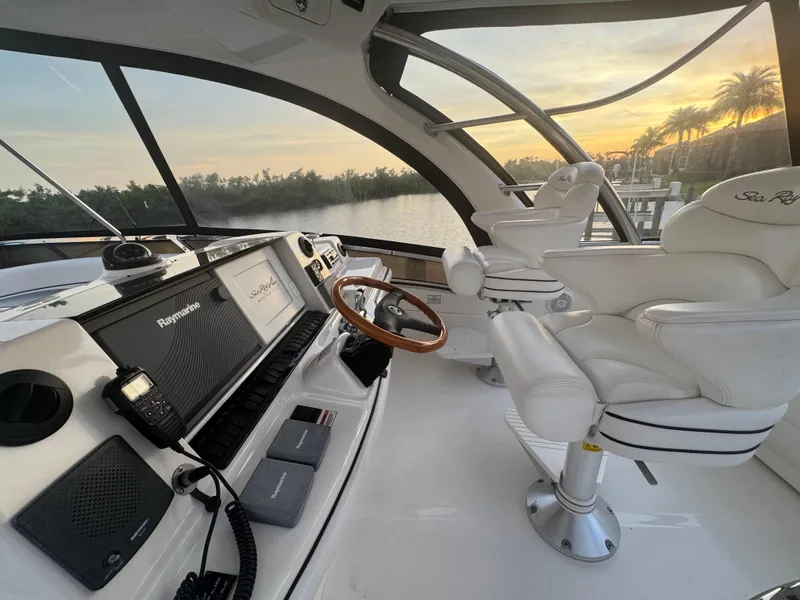 Slide: The Image of Luxurious 2007 Sea Ray 52 Sedan Bridge helm with white leather seats and sunset view. - 7