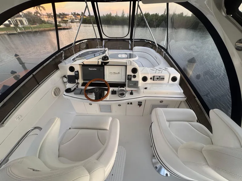 Slide: The Image of 2007 Sea Ray 52 Sedan Bridge helm with luxurious seating and advanced navigation controls. - 8