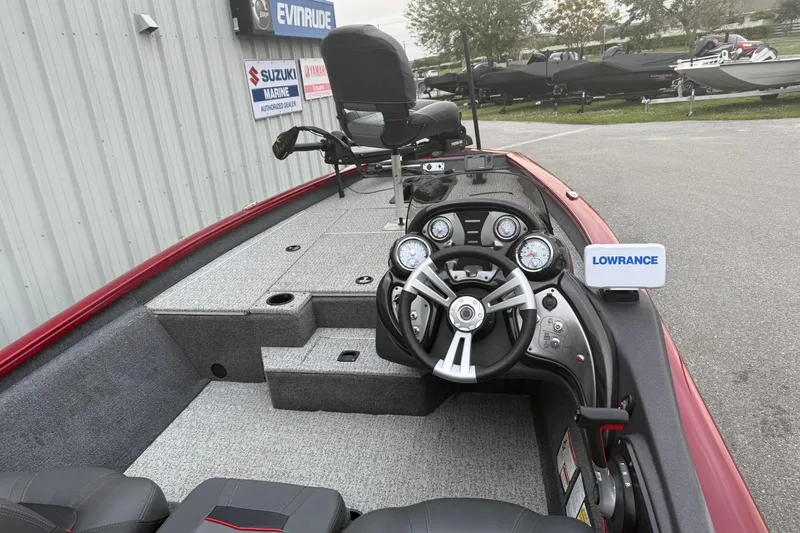 Slide: The Image of 2003 Bass Tracker PT175 boat interior with steering wheel and Lowrance equipment. - 4