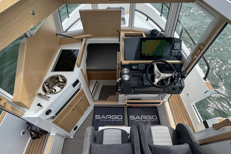 Slide: The Image of Interior of Sargo 28 boat, 2025 model, featuring modern helm and kitchen. - 13