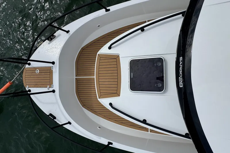 Slide: The Image of Top view of 2025 Sargo 28 boat deck with wood finish and hatch. - 21