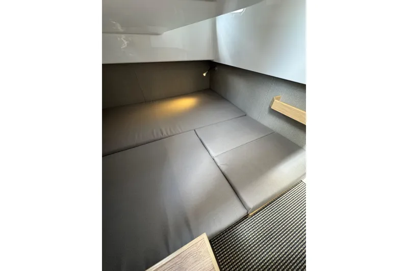 Slide: The Image of Interior cabin of 2025 Sargo 28 boat with cozy seating and ambient lighting. - 25