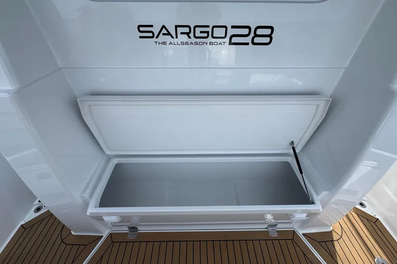 Slide: The Image of Sargo 28 boat storage compartment, 2025 model, open on teak deck. - 28