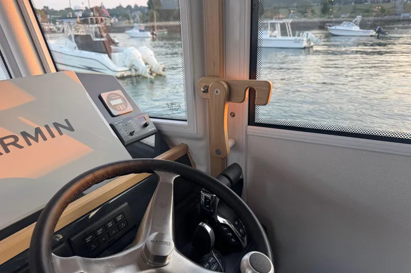 Slide: The Image of Interior view of Sargo 28 boat, 2025 model, featuring steering wheel and Garmin device. - 4