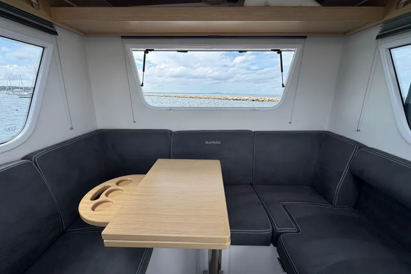 Slide: The Image of Interior of Sargo 28 boat, 2025 model, featuring table and seating area. - 9