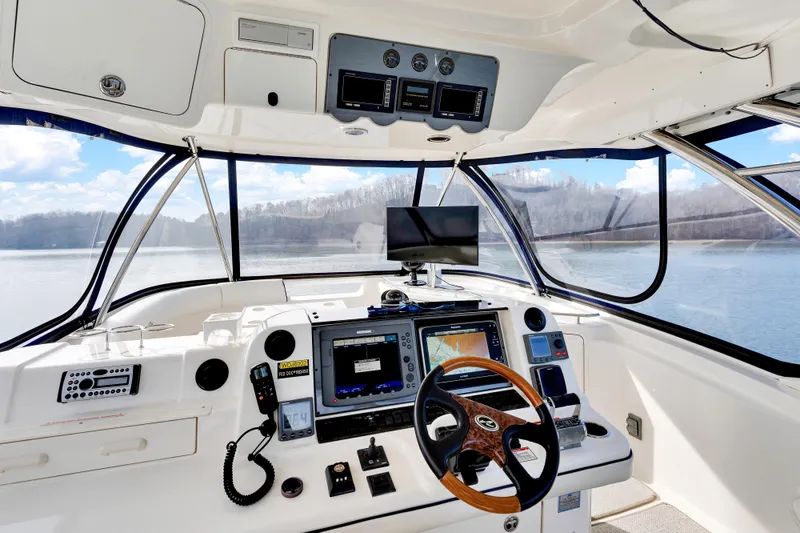 Slide: The Image of 2006 Sea Ray 58 Sedan Bridge helm with advanced navigation equipment and panoramic water views. - 14