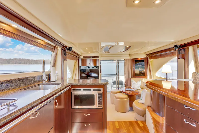 Slide: The Image of Luxurious interior of 2006 Sea Ray 58 Sedan Bridge yacht with modern kitchen and seating area. - 23