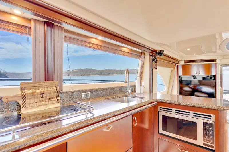Slide: The Image of Luxurious kitchen interior of 2006 Sea Ray 58 Sedan Bridge yacht with scenic window view. - 24