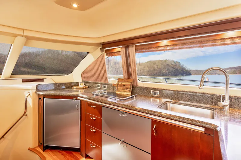 Slide: The Image of Luxurious kitchen interior of 2006 Sea Ray 58 Sedan Bridge yacht with scenic window view. - 25