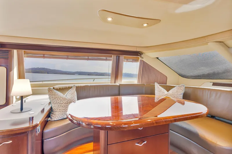 Slide: The Image of Luxurious interior of 2006 Sea Ray 58 Sedan Bridge yacht with elegant seating and table. - 26