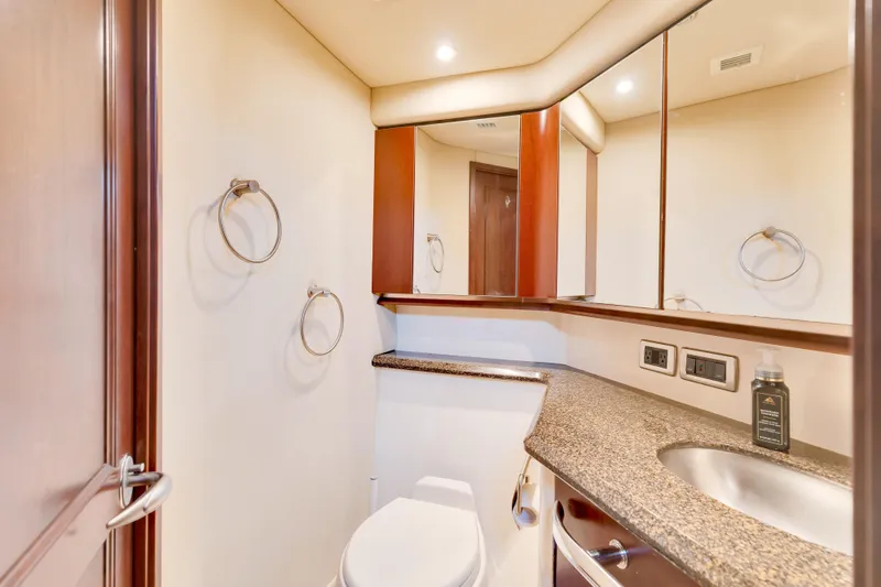 Slide: The Image of Luxurious bathroom in 2006 Sea Ray 58 Sedan Bridge yacht with granite countertop and modern fixtures. - 36