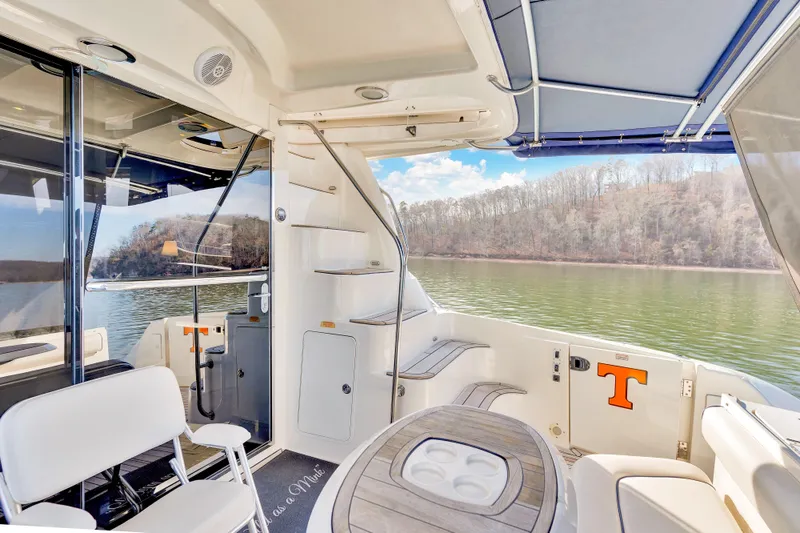 Slide: The Image of 2006 Sea Ray 58 Sedan Bridge yacht interior with seating and scenic lake view. - 40