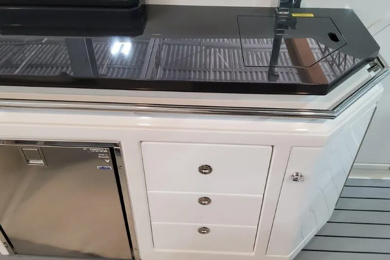 Slide: The Image of 2022 Formula 380 Super Sport Crossover OB interior with sleek cabinetry and grill. - 35