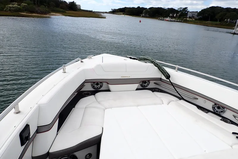Slide: The Image of 2022 Formula 380 Super Sport Crossover OB boat on calm water, featuring luxurious seating. - 42