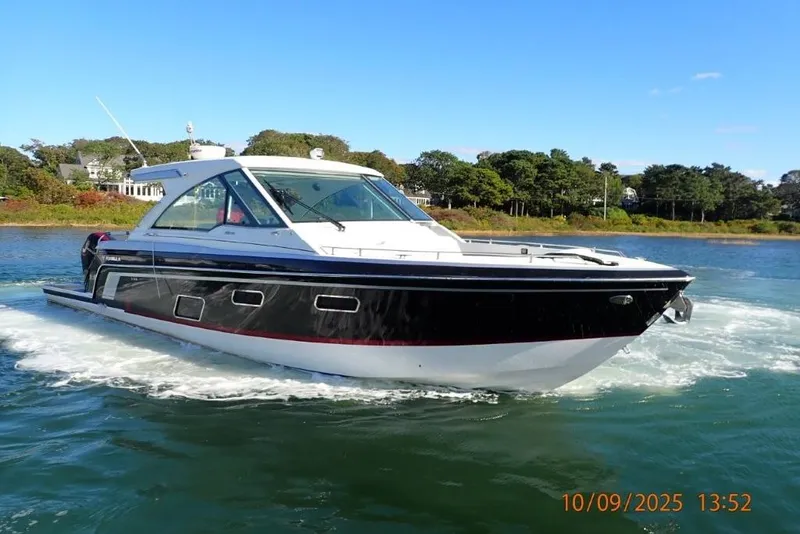 Slide: The Image of 2022 Formula 380 Super Sport Crossover OB docked with twin Mercury outboard engines. - 7