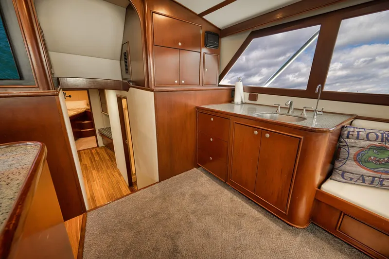 Slide: The Image of Luxurious interior of 2002 Paul Mann 60 Custom Carolina yacht with wooden cabinetry and seating. - 12