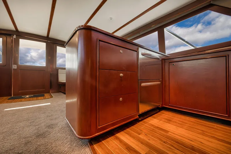 Slide: The Image of Interior of 2002 Paul Mann 60 Custom Carolina yacht with wooden cabinetry and panoramic windows. - 13