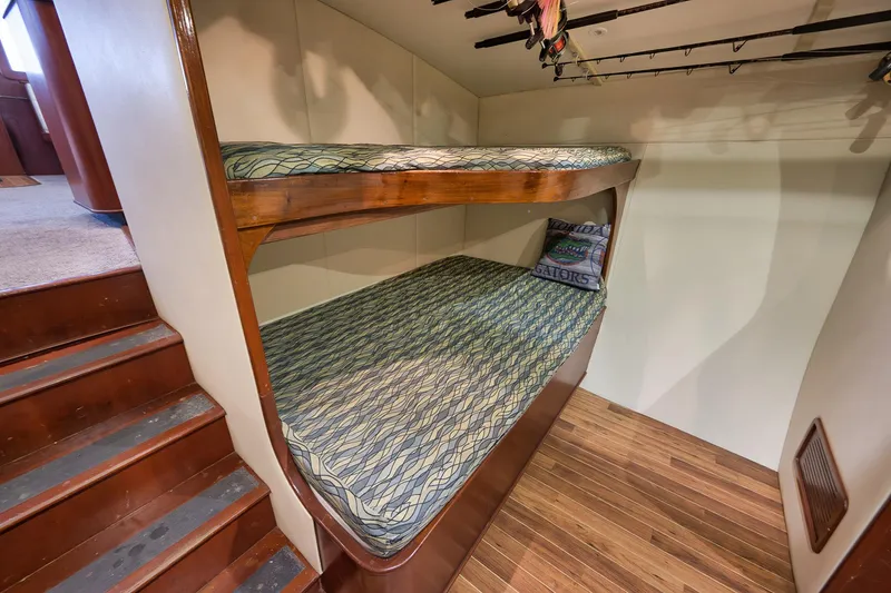 Slide: The Image of Bunk beds in 2002 Paul Mann 60 Custom Carolina yacht with fishing rods overhead. - 14