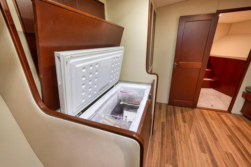 Slide: The Image of Interior of 2002 Paul Mann 60 Custom Carolina yacht with open freezer and wooden flooring. - 17