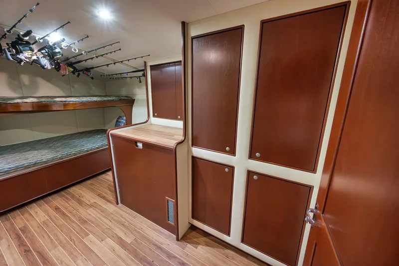 Slide: The Image of Interior of 2002 Paul Mann 60 Custom Carolina yacht with wooden cabinets and fishing rods. - 18