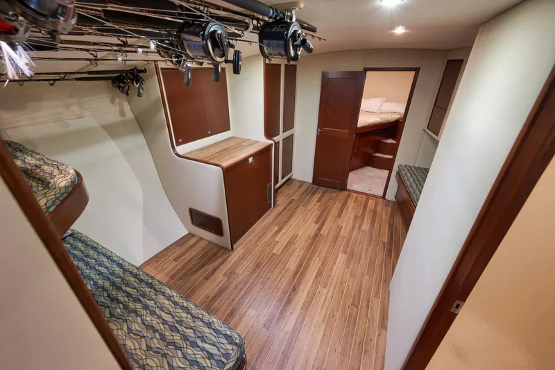 Slide: The Image of Interior of 2002 Paul Mann 60 Custom Carolina yacht with wooden flooring and fishing rods. - 19