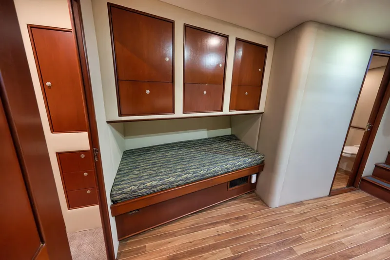 Slide: The Image of Interior of 2002 Paul Mann 60 Custom Carolina yacht with wooden cabinets and bed. - 21