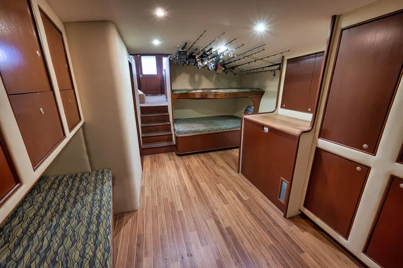 Slide: The Image of Interior of 2002 Paul Mann 60 Custom Carolina boat with wood flooring and fishing rods. - 22