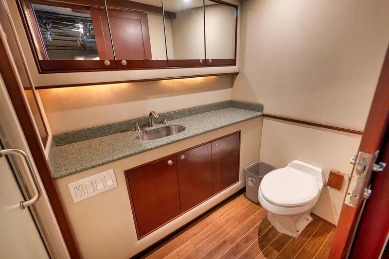 Slide: The Image of Luxurious bathroom in 2002 Paul Mann 60 Custom Carolina yacht with wood flooring and modern fixtures. - 25