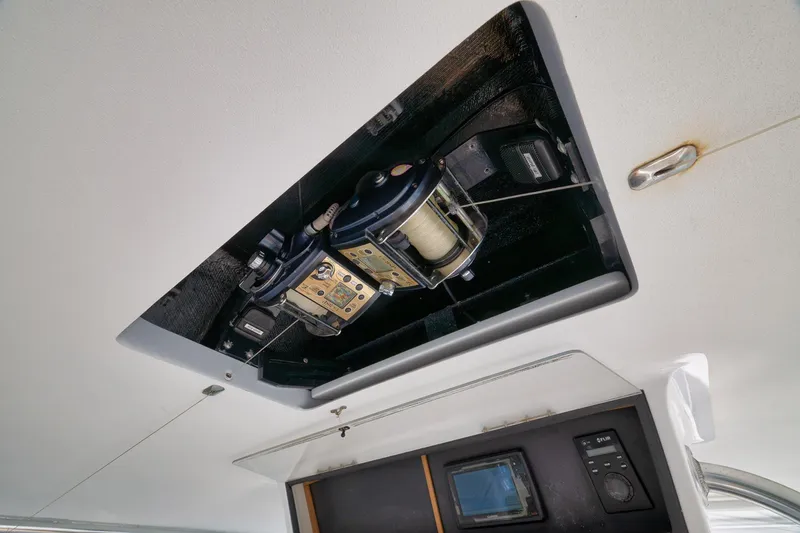Slide: The Image of Ceiling-mounted fishing reel on 2002 Paul Mann 60 Custom Carolina boat. - 31