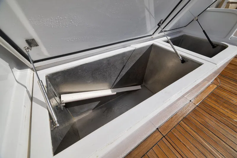 Slide: The Image of Open storage compartments on 2002 Paul Mann 60 Custom Carolina boat deck. - 47