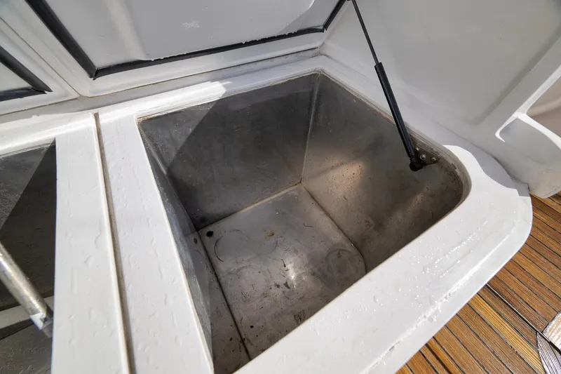 Slide: The Image of Open storage compartment on 2002 Paul Mann 60 Custom Carolina boat. - 48