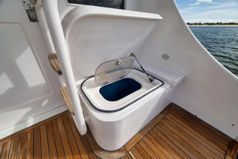 Slide: The Image of Livewell on 2002 Paul Mann 60 Custom Carolina boat, featuring teak flooring and ocean view. - 49