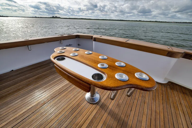 Slide: The Image of Luxury wooden deck of 2002 Paul Mann 60 Custom Carolina yacht, featuring a stylish fishing table. - 52