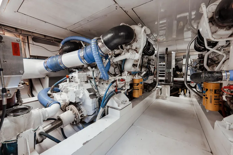 Slide: The Image of Engine room of 2002 Paul Mann 60 Custom Carolina yacht, featuring Caterpillar machinery. - 56