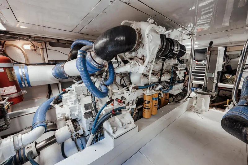 Slide: The Image of Engine room of 2002 Paul Mann 60 Custom Carolina yacht, featuring complex machinery and piping. - 59