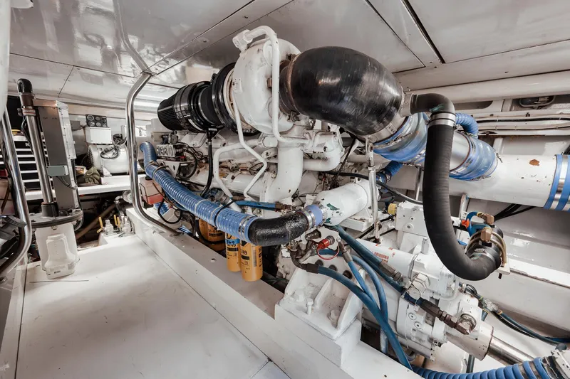 Slide: The Image of Engine room of 2002 Paul Mann 60 Custom Carolina yacht, featuring complex machinery and piping. - 60