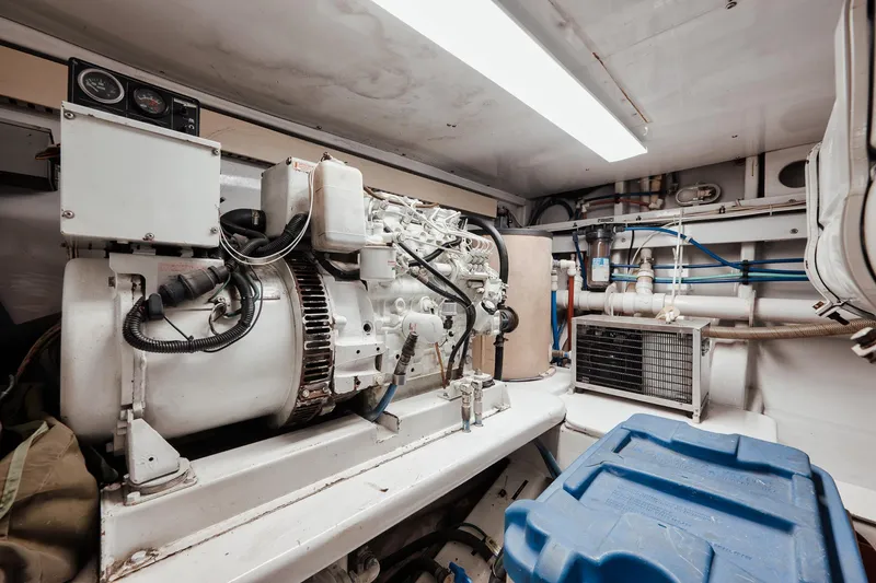 Slide: The Image of Engine room of 2002 Paul Mann 60 Custom Carolina boat, featuring mechanical components and equipment. - 62