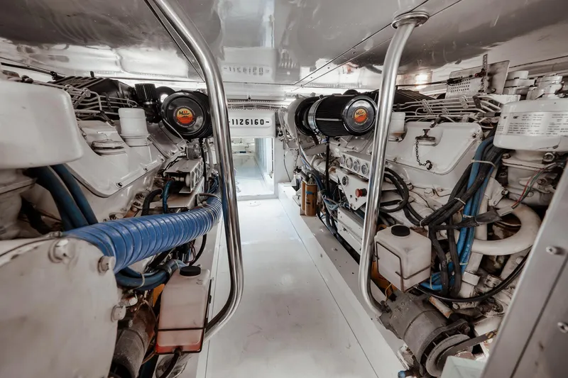 Slide: The Image of Engine room of 2002 Paul Mann 60 Custom Carolina yacht, showcasing dual engines and mechanical components. - 63