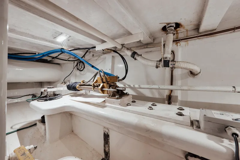 Slide: The Image of Engine room of 2002 Paul Mann 60 Custom Carolina boat, showing mechanical components and piping. - 64