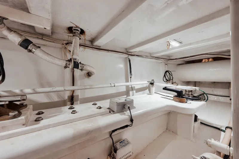 Slide: The Image of Engine room of 2002 Paul Mann 60 Custom Carolina boat, showcasing pipes and equipment. - 65