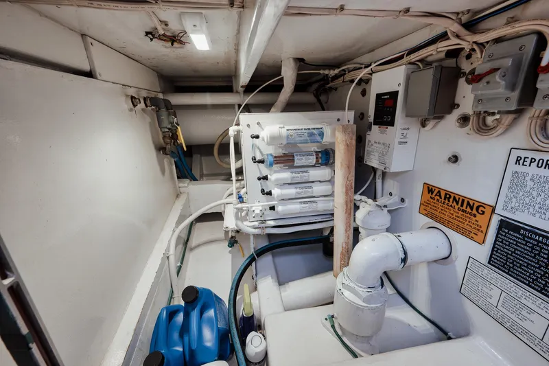 Slide: The Image of Engine room of 2002 Paul Mann 60 Custom Carolina yacht, featuring water filtration system. - 66