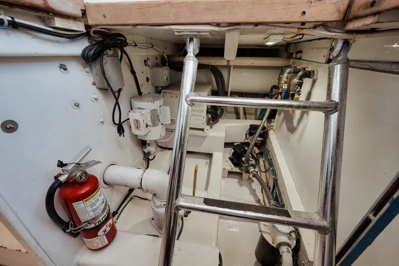 Slide: The Image of Engine room of 2002 Paul Mann 60 Custom Carolina boat with fire extinguisher and equipment. - 68