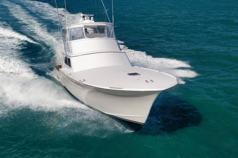 Slide: The Image of 2002 Paul Mann 60 Custom Carolina yacht cruising on open water. - 76