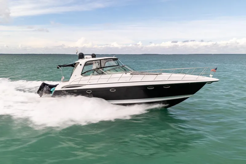 Slide: The Image of 2005 Formula 48 Yacht cruising on open water under a clear sky. - 10