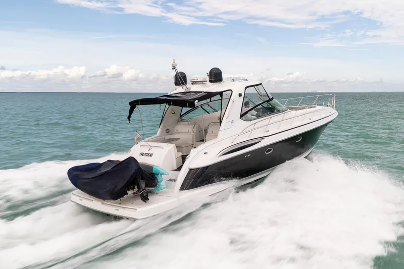 Slide: The Image of 2005 Formula 48 Yacht cruising on open water under a clear sky. - 11
